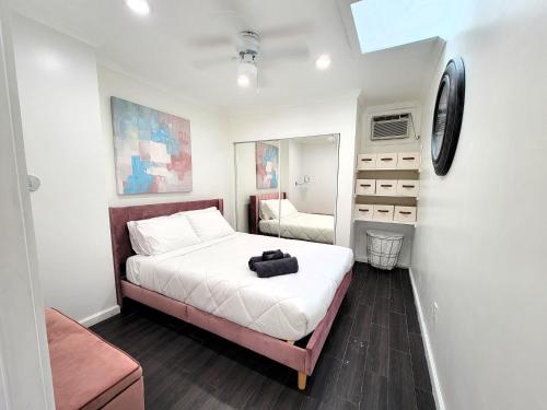 a small bedroom with a bed and a mirror at Two bedroom private guesthouse in great location Close to Melrose Hollywood sign and attractions in Los Angeles