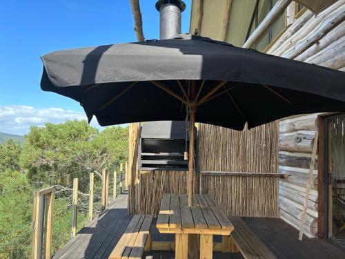 a black umbrella sitting on a wooden deck at Villa Keys in Wilderness