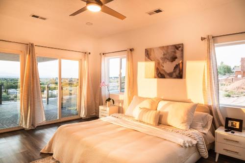 a bedroom with a bed and large windows at New House in the Palisades Hills in Albuquerque
