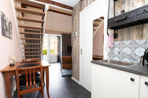 a kitchen with a spiral staircase in a tiny house at B&B De Hoffstal in Sassenheim