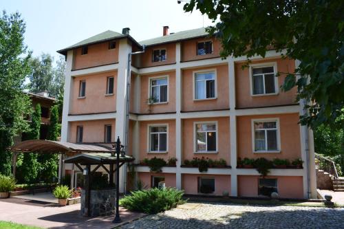 a large orange building with a roof at Hotel Tintyava 2 in Varshets