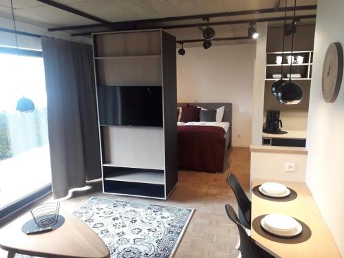 a living room with a dining table and a bedroom at Lieblingsplatz am Kurpark in Brilon