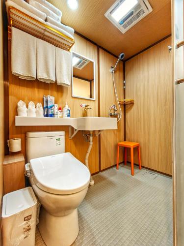 a bathroom with a toilet and a sink at Pipa Hotel Datong in Datong