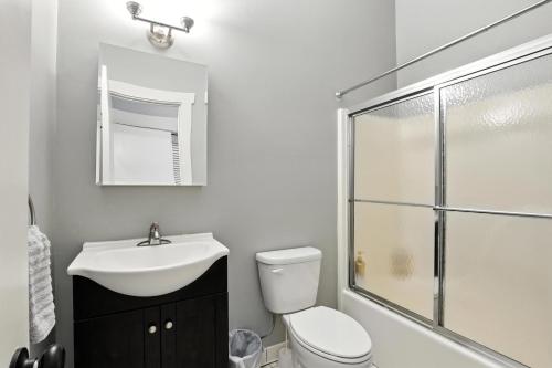 a bathroom with a toilet and a sink and a shower at NEW LISTING The Townie Retreat - Walk to Stadium in Athens