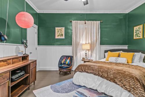 a bedroom with a bed and a green wall at Lenoir Cottage w covered patio and fire pit in Athens