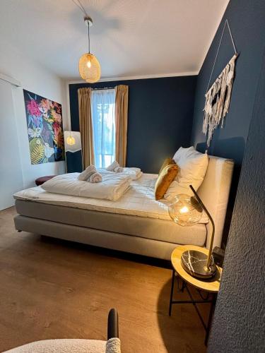 a bedroom with a bed and a table with a lamp at Zentral und Stilvoll Nahe Kurpark und Bali Therme in Bad Oeynhausen