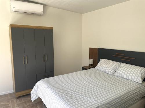a bedroom with a large bed and a closet at Colinas House in Ciudad de la Costa