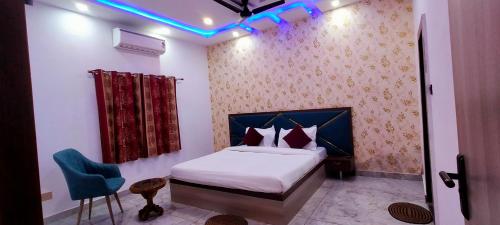a bedroom with a bed and a blue light at Kashi Satya Luxury Stay in Varanasi