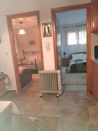 a view of a room with a bedroom and a radiator at Villa Asimidou in Agia Paraskevi