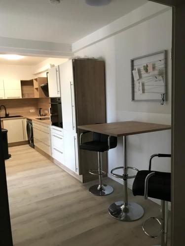a kitchen with a table and two bar stools at Meckenheim in Meckenheim