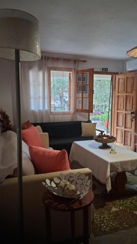 a living room with a couch and a table at Villa Asimidou in Agia Paraskevi