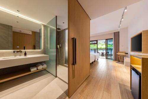 a bathroom with a sink and a mirror at The Yun Collection Sanya in Sanya