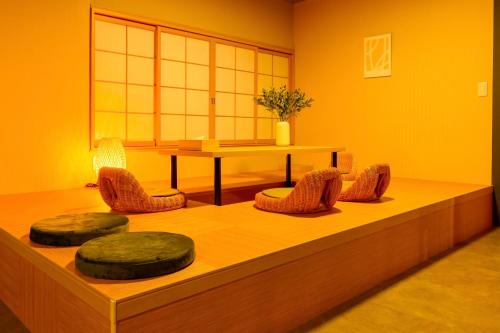 a room with chairs and a table and a table and a tablektop at Tokinoma Furano in Furano