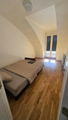 a bedroom with a bed and a wooden floor at Spring 2 in Petrovaradin
