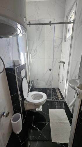 a bathroom with a white toilet and a sink at Spring 2 in Petrovaradin