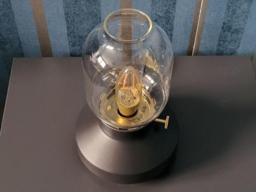 a glass jar with a candle in it on a table at Retroversum Themen-Ferienwohnung in Bad Oeynhausen