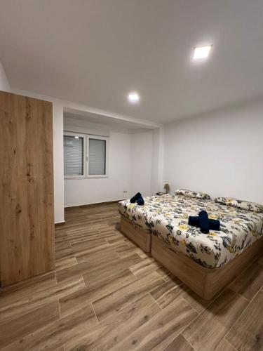 a bedroom with a bed and a wooden floor at Modern apartment 2 Barcelona in Santa Coloma de Gramanet