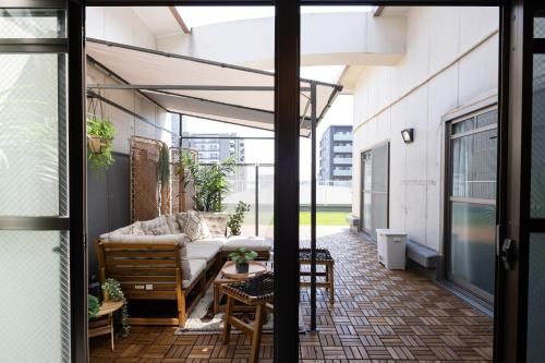 a patio with a couch and a table at b&難波1号店 in Osaka