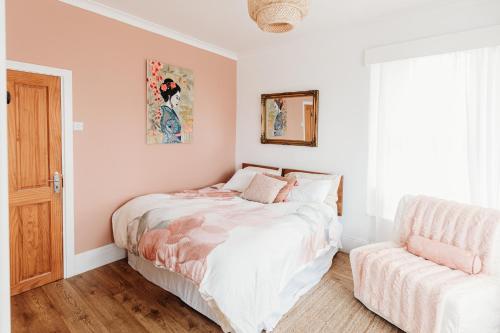 a bedroom with a bed and a chair at Seaview Surf Studios in Newquay