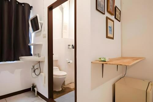 a bathroom with a toilet and a sink at X GO INN Asiatique BKK - โกอินน์ เอเชียทีค เจริญกรุง in Godown