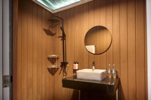 a bathroom with a sink and a mirror at Koh Sdach Resort by EHM in Kaoh Sdach