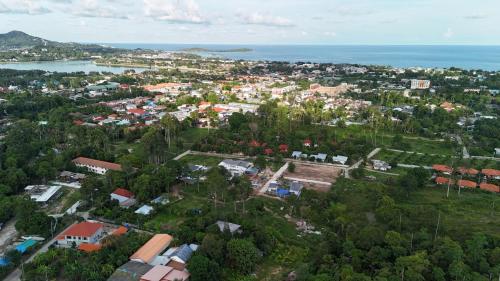 an aerial view of a city with the ocean at The Green Horizon Villa Chaweng Hill in Koh Samui 