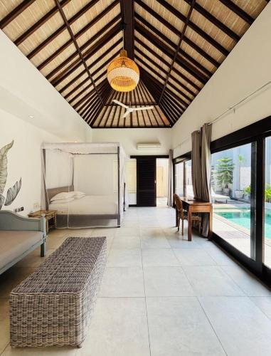 a living room with a bed and a pool at Zoe Villa Canggu Bali in Canggu