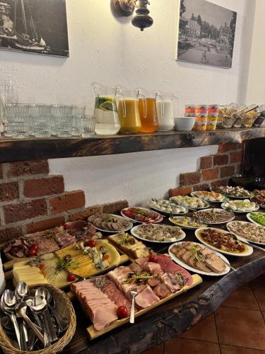 a buffet with many plates of food on a table at Hotel Kopernik in Frombork