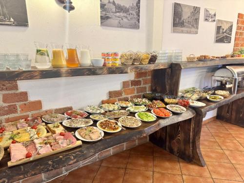 a buffet line with many different types of food at Hotel Kopernik in Frombork