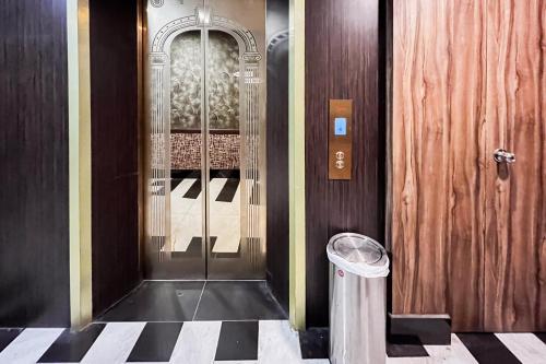 a glass door in a building with a trash can at RedDoorz Plus at Paragon Nagoya Hotel Batam in Nagoya