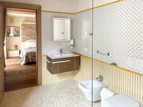a bathroom with a shower and a sink and a toilet at Le 4 Camere in Roverchiara