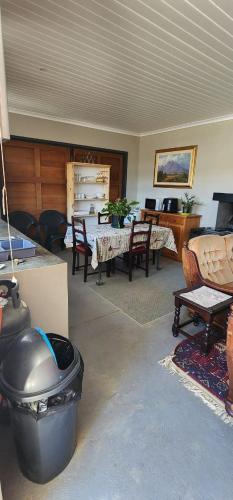 a living room filled with furniture and a table at Die Steenkamps in Sutherland
