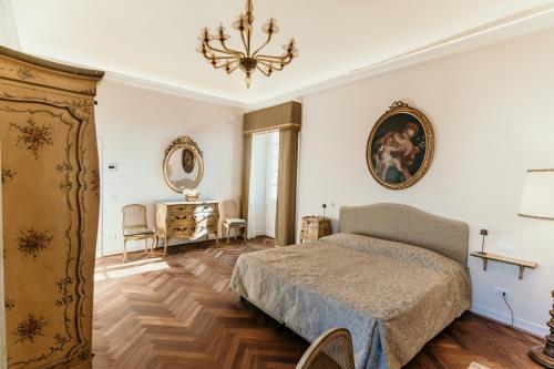 a bedroom with a bed and a chandelier at Castello di Pasturana in Pasturana