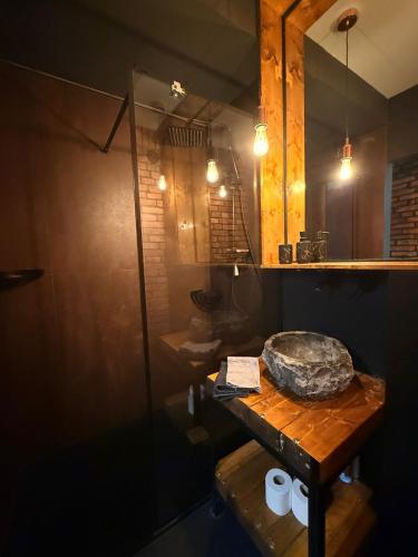 a bathroom with a shower and a wooden table at Apartament Katowicka 23 in Poznań