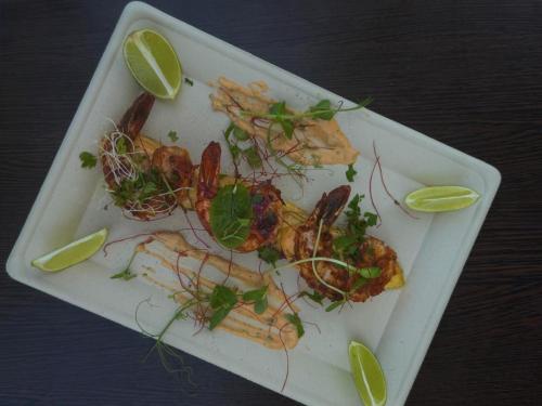 a plate of food with shrimp and other foods at MILITARY Guest Inn in Drawsko Pomorskie