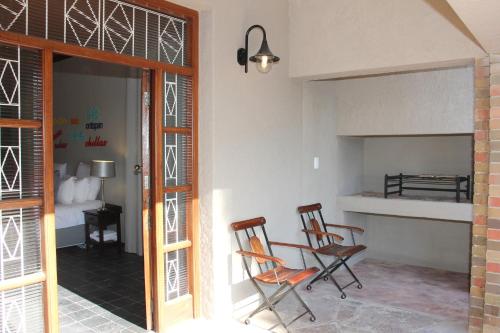2 sedie sedute in una stanza con cucina di Augrabies Valle Guesthouse ad Augrabies