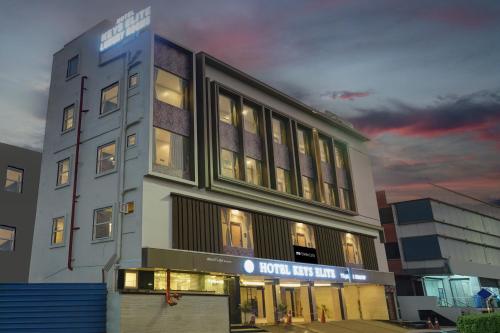 a hotel building with lights on in the evening at Super Collection O KEYS ELITE in Vijayawada