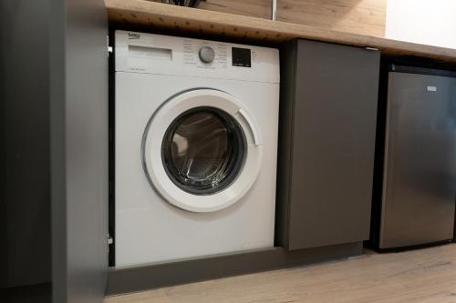 a white washer and dryer in a kitchen at ADLER Room Suite in Łódź