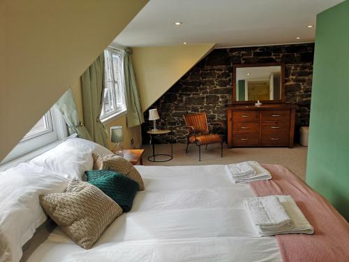 a bedroom with a large white bed in a room at Friars Shott Cottage in Inverness