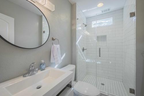 a white bathroom with a sink and a shower at The Complex on Bobbin Mills in Athens