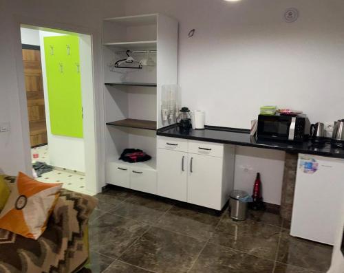 a kitchen with white cabinets and a counter top at River Side Apartment in Prizren