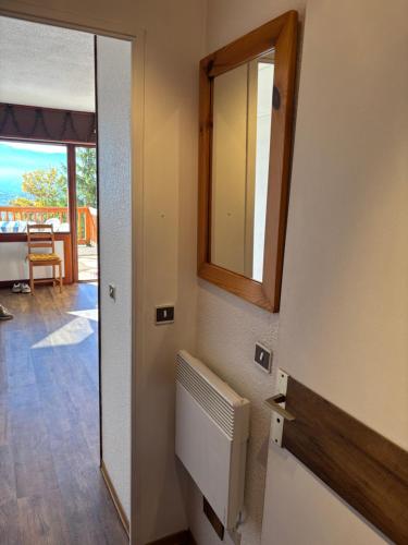 a bathroom with a mirror and a door to a porch at Le cocon du Canigou in Font-Romeu