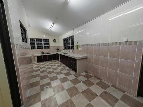 a large bathroom with two sinks and a tiled floor at Be Stay Ipoh with parking - 14pax, 5Rooms in Ipoh