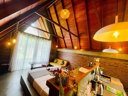 a bedroom with a bed in a room with a window at Nirvana Lodges in Kumbalgama