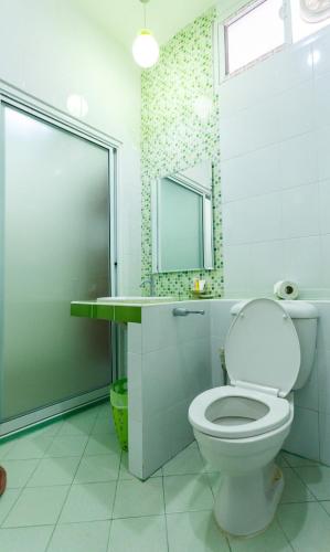 a bathroom with a toilet and a sink and a mirror at S Hotel Kanchanaburi in Kanchanaburi