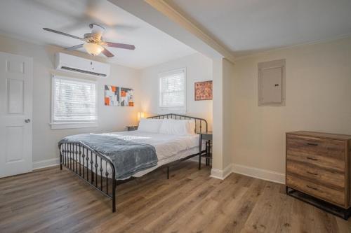 a bedroom with a bed and a ceiling fan at Caras Cottage - 2 miles from Sanford Stadium in Athens