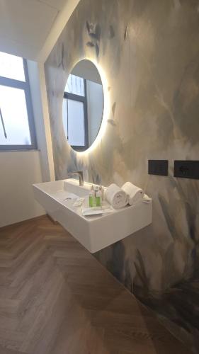 a bathroom with a sink and a mirror at Mokinba Hotels Baviera in Milan