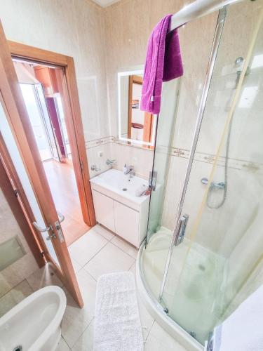 a bathroom with a shower and a sink at Loreto Rose, Panoramic Ocean and Mountain View in Arco da Calheta