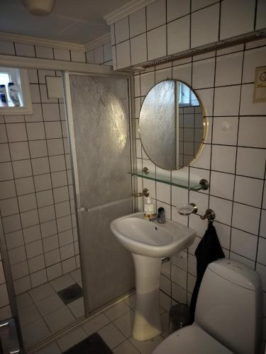 a bathroom with a sink and a toilet and a mirror at Prekestolen, Pulpit Rock in Strand