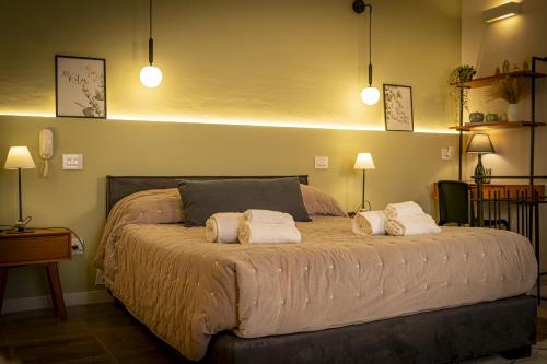 a bedroom with a large bed with two pillows at Affittacamere Casa Matilde in Gualdo Tadino